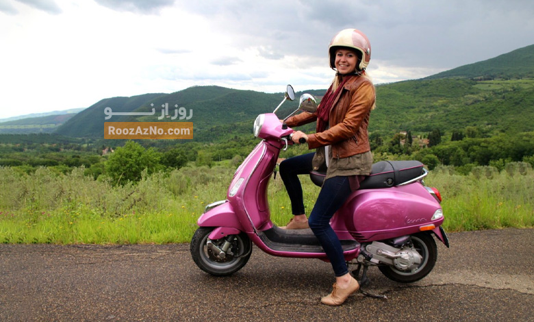 Women riding a pink Vespa